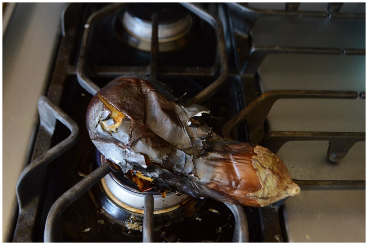 An rggplant on a gas burner.