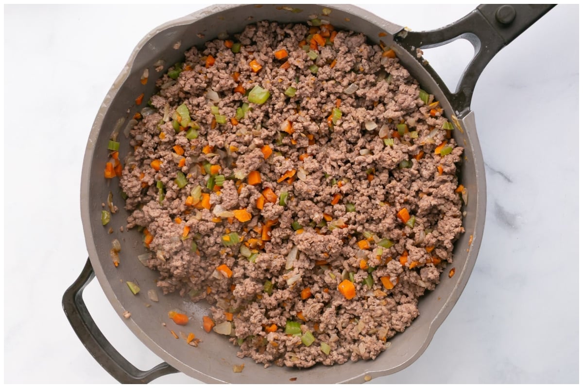 A large non stick skillet with meat mixture.