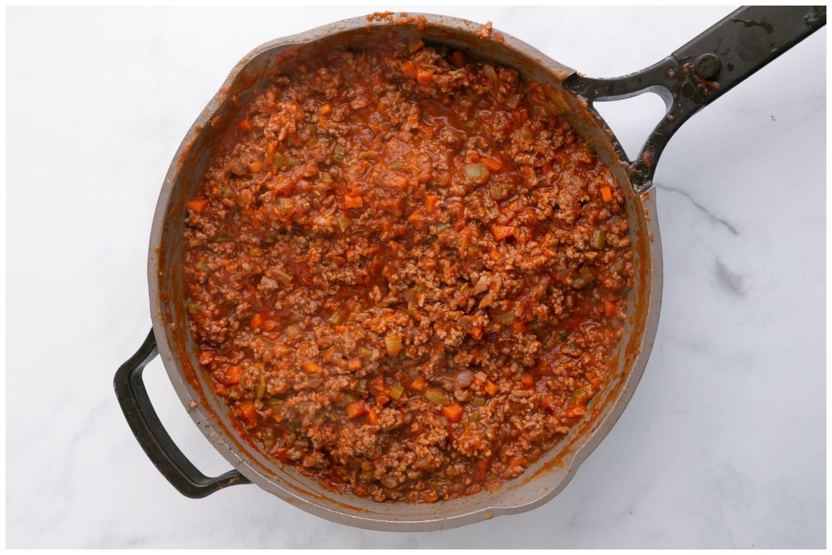 A large skillet with meat sauce.