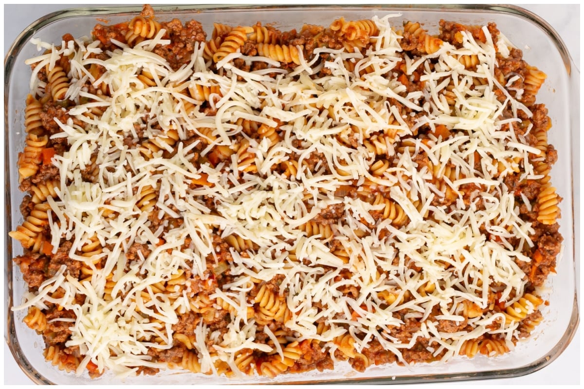 A baking dish with pasta bolognese covered with mozzarela cheese.