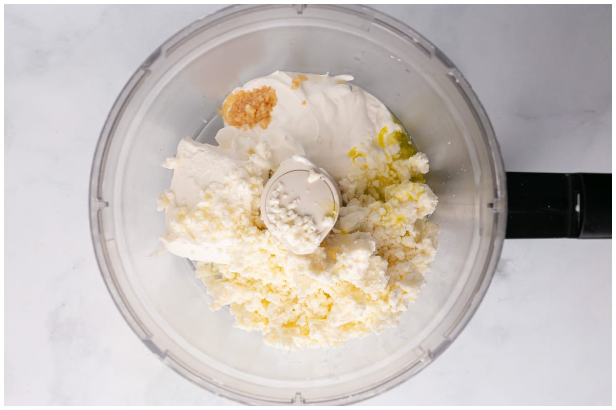 Ingredients for the cheese mixture in the bowl of the food processor.