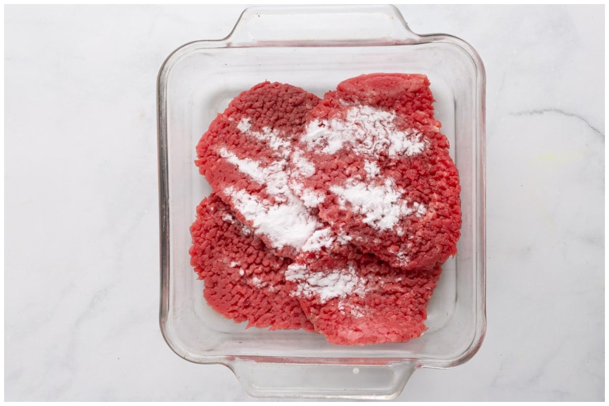 Cube steaks in a glass bowl.