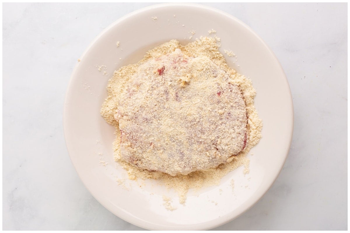 A piece of cube steak breadded on a plate.
