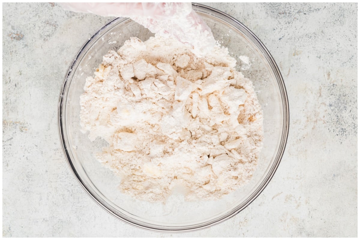 A large glass bowl with flour butter mixture.