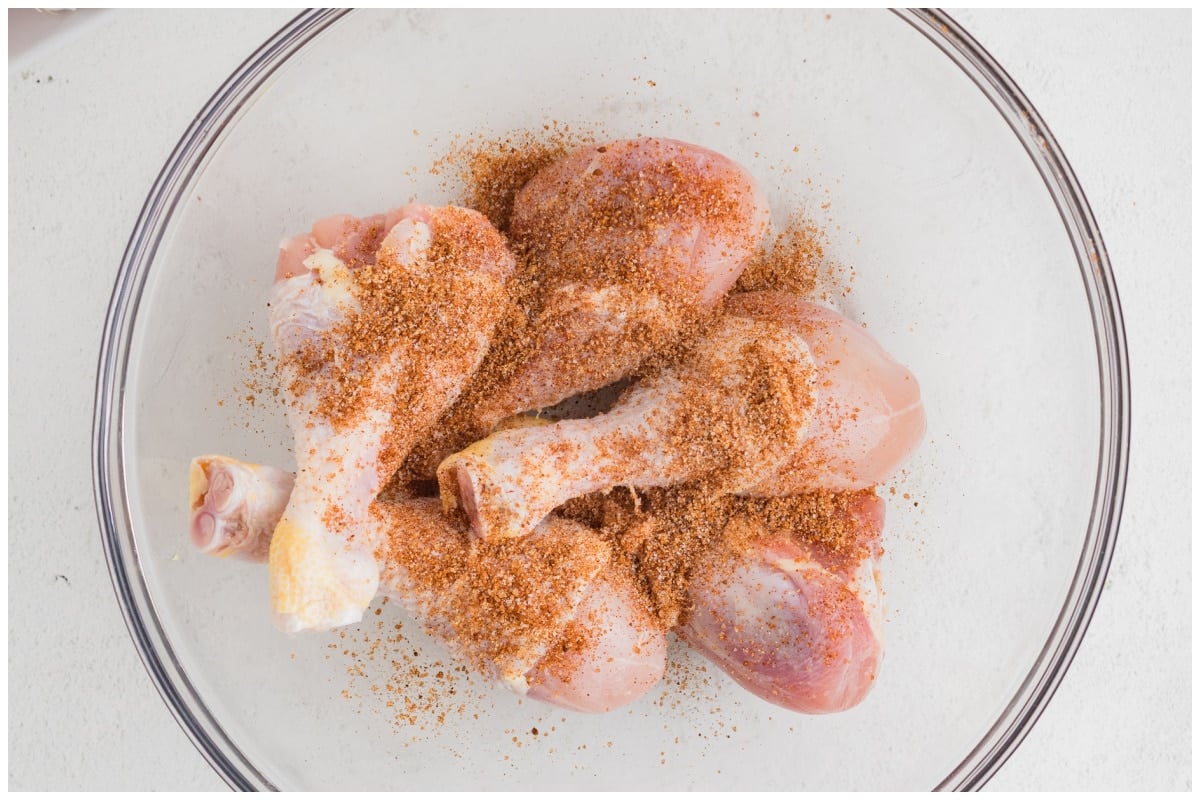 Drumsticks in a glass bowl with spices.