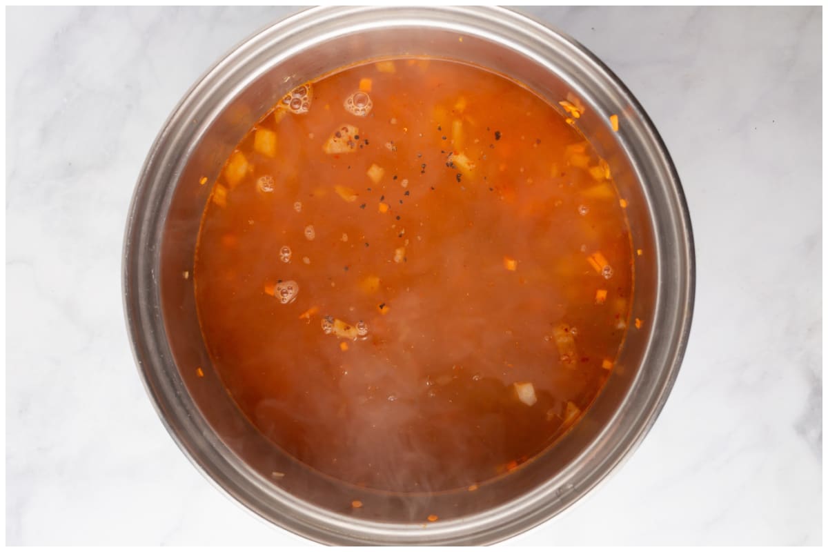A pot with lentils and water.