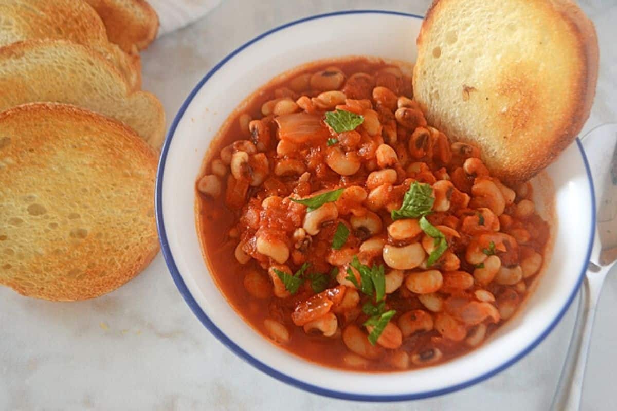 An overhead image of a white bowl with black eyed peas.