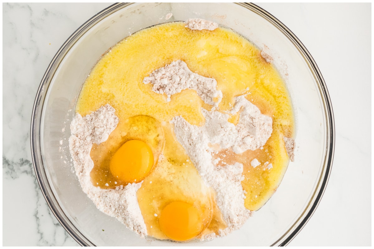 Glass bowl with snickerdoodle ingredients mixed.