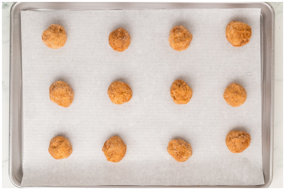 Snickerdoodle cookie dough on a cookie sheet.
