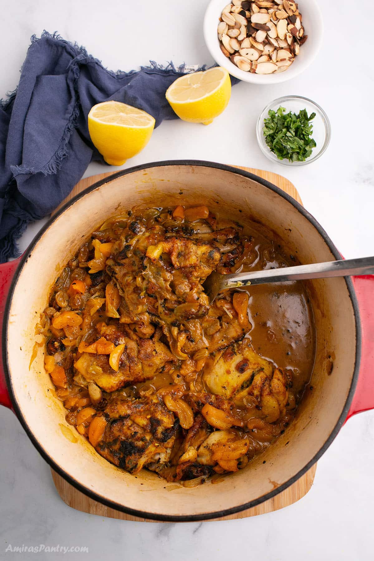 An overhead image of a deep pot with chicken tagine.