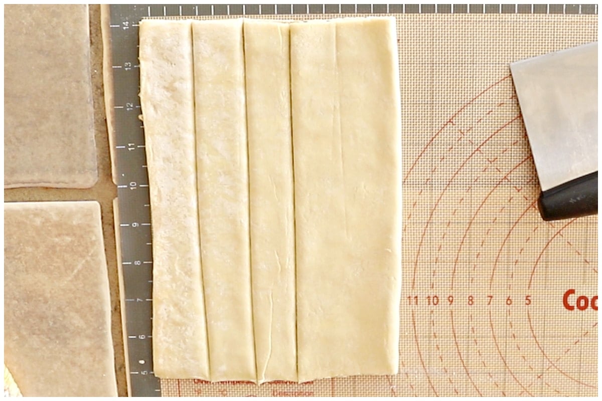 Puff pastery sheet folded on a countertop.