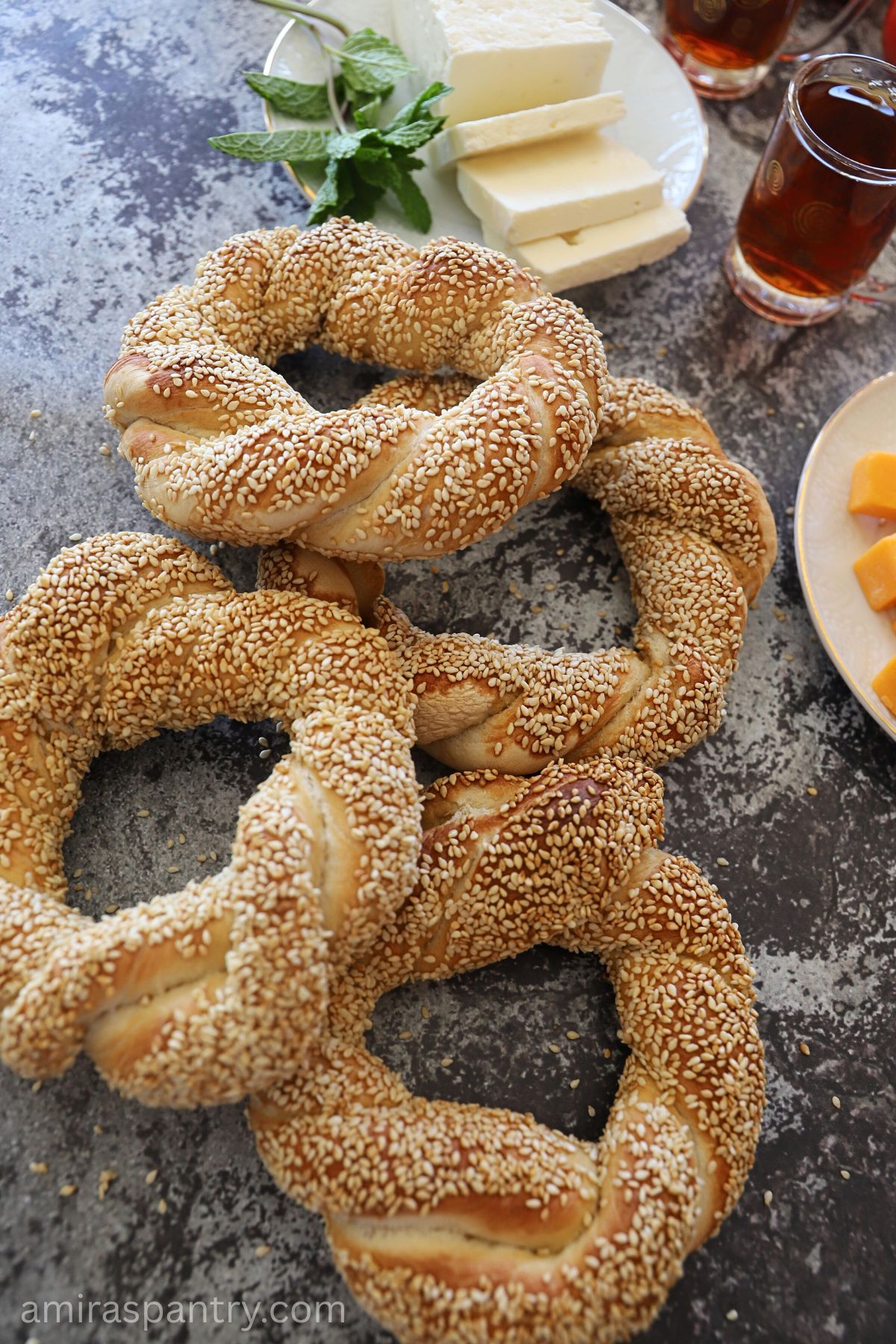 Turkish simit bread coated in sesame on a countertop.