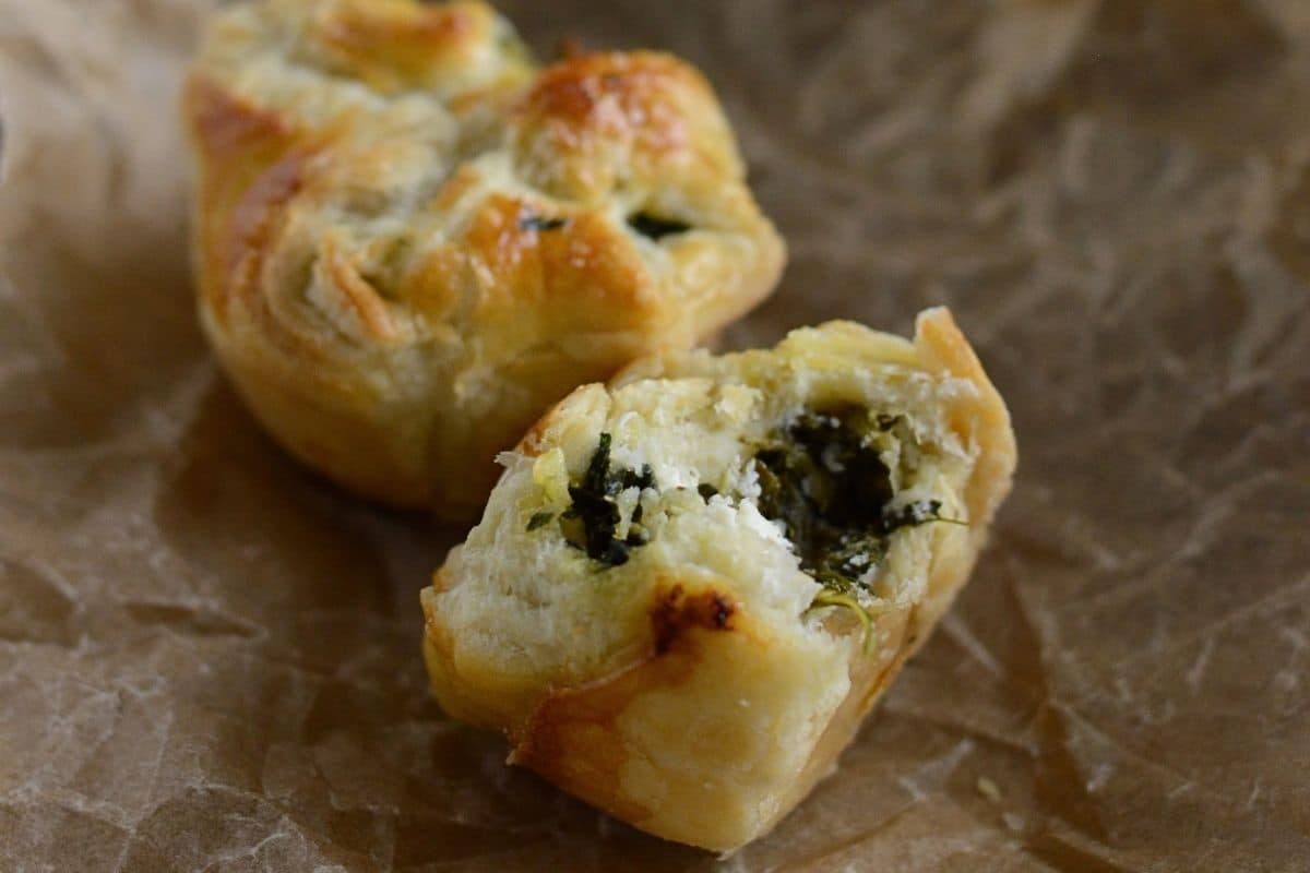 Spanakopita puff cut in galf to show filling.
