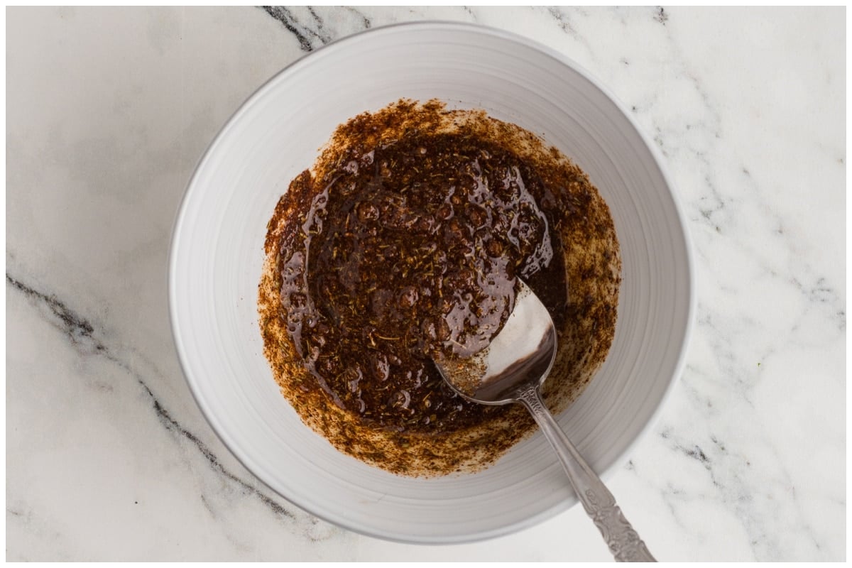 Homemade cajun spice mix tossed with oil in a small bowl.