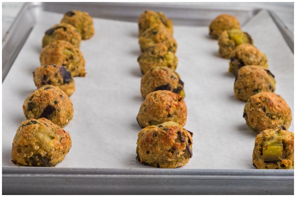 Baked eggplant balls on a baking sheet.