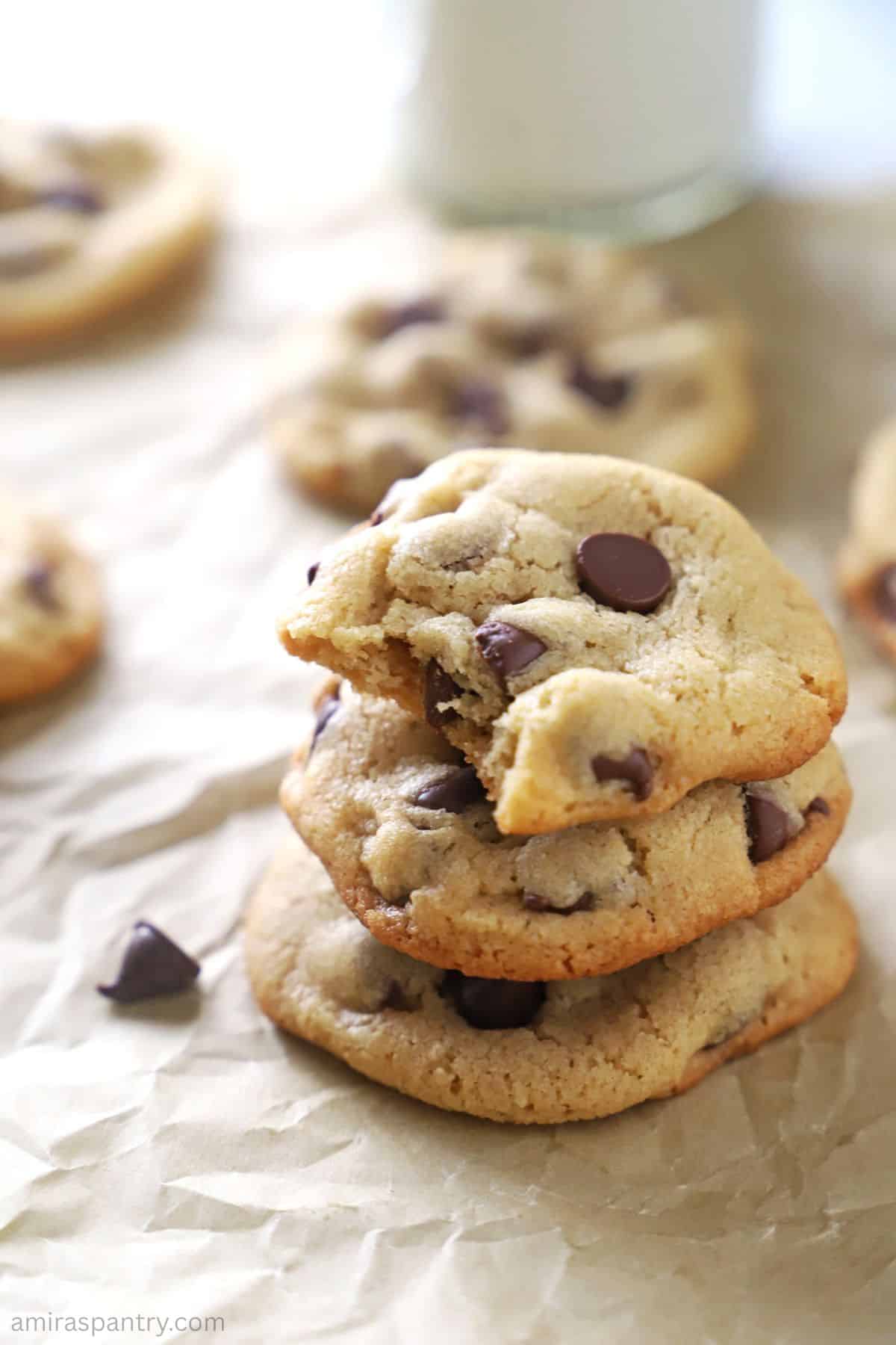 A stack of cookies with a bite taken from the top one.