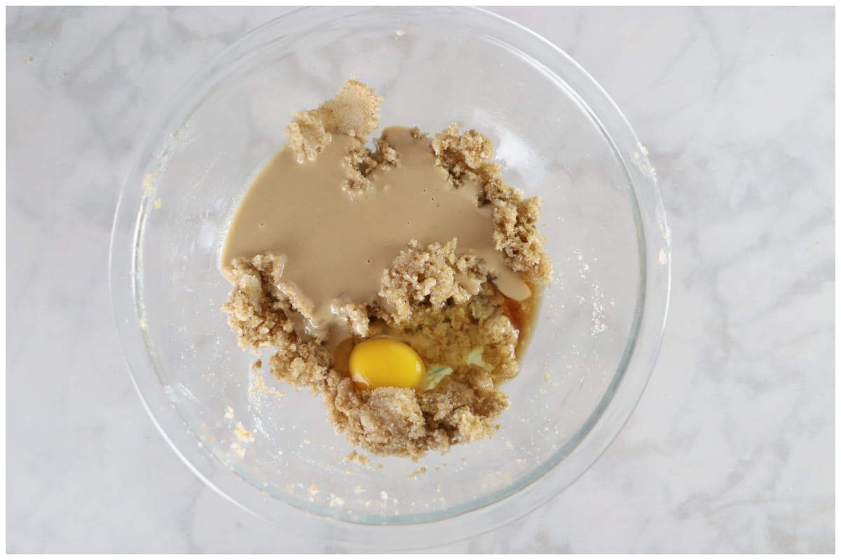 A glass bowl with wet cookies ingredients.