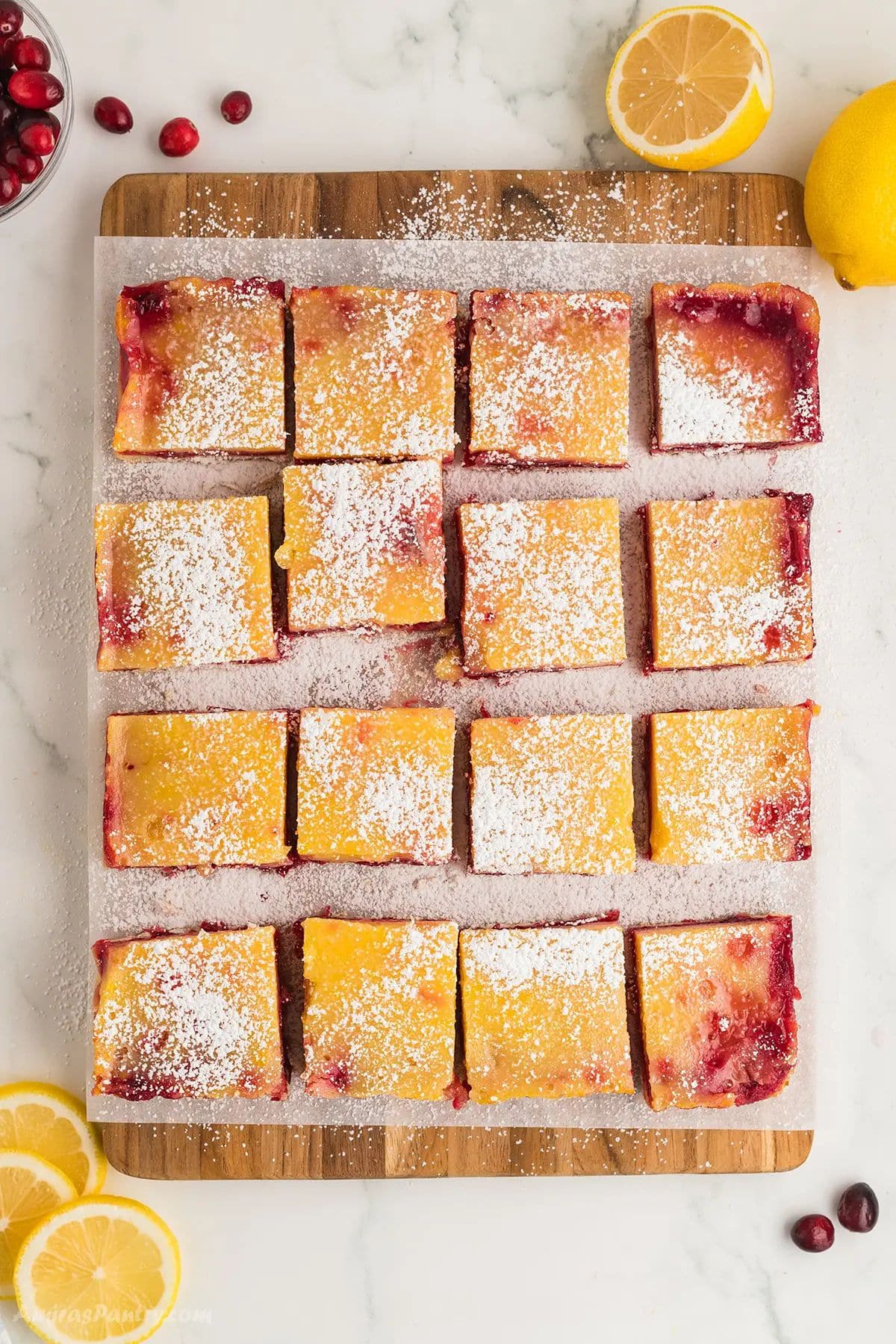 An overhead image of a slap of lemon bars cut into squares.