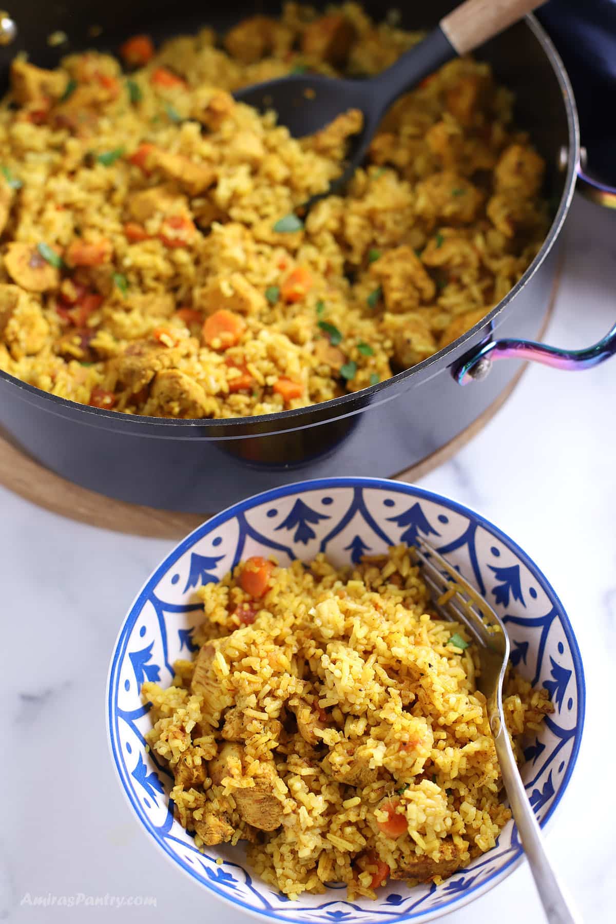 Moroccan rice in a bowl with a spoon in it.