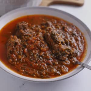 A large bowl of spinach beef stew.