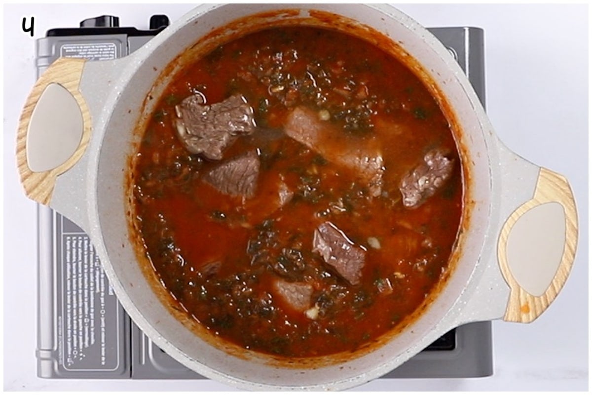 A large pot of spinach stew with beef.