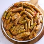 A white round platter of cabbage rolls.