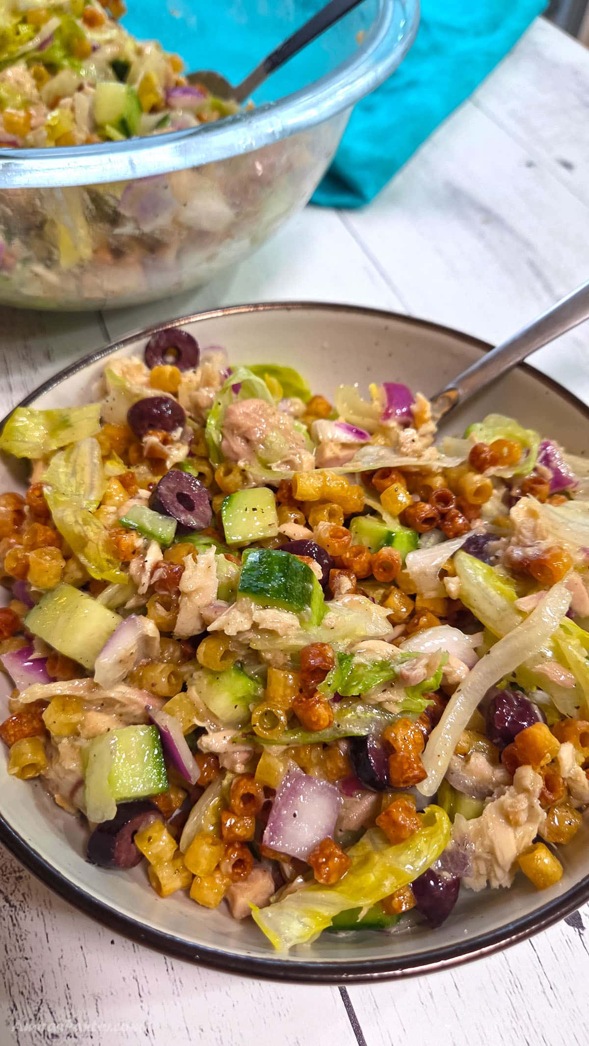 crispy pasta salad on a bowl with a spoon.