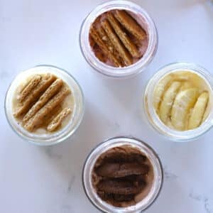 An overhead image of 4 jars with cheesecake.