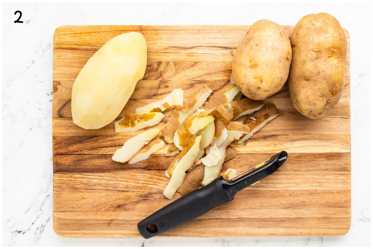 Peeling potatoes on a wooden board.