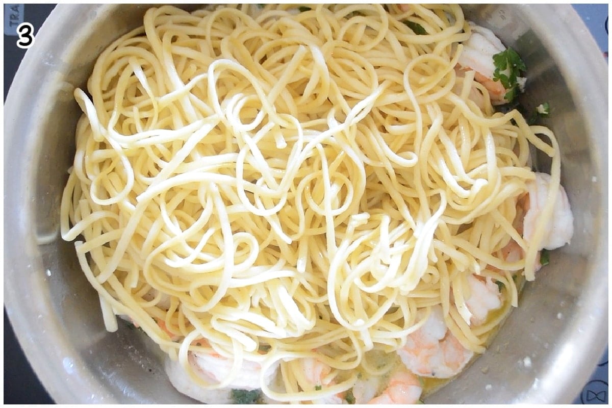 A large pot of shrimp topped with pasta.