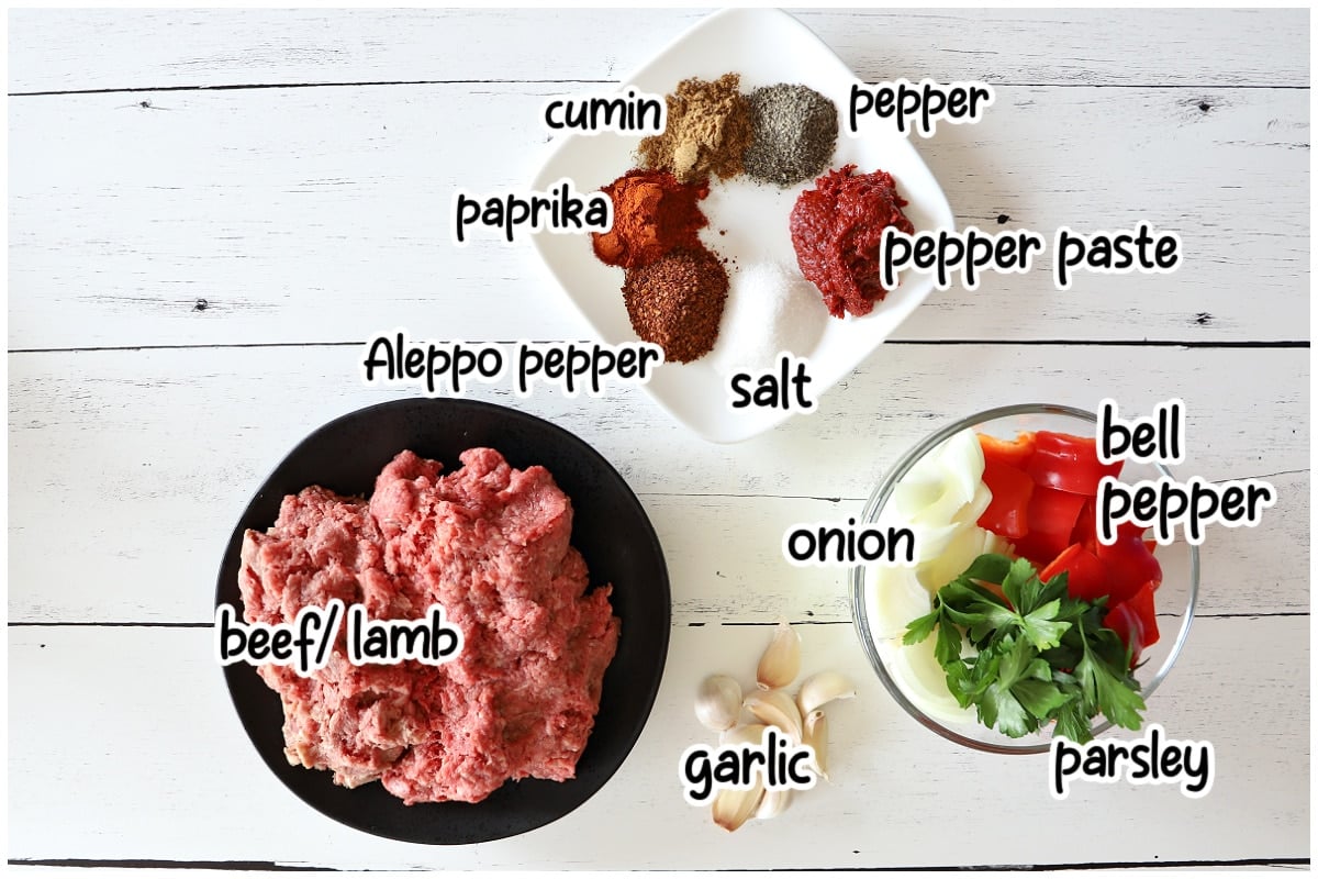 Ingredients for the Adana Kebab on a wooden board.