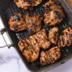 An overhead image of a grilling pan filled with balsamic chicken.