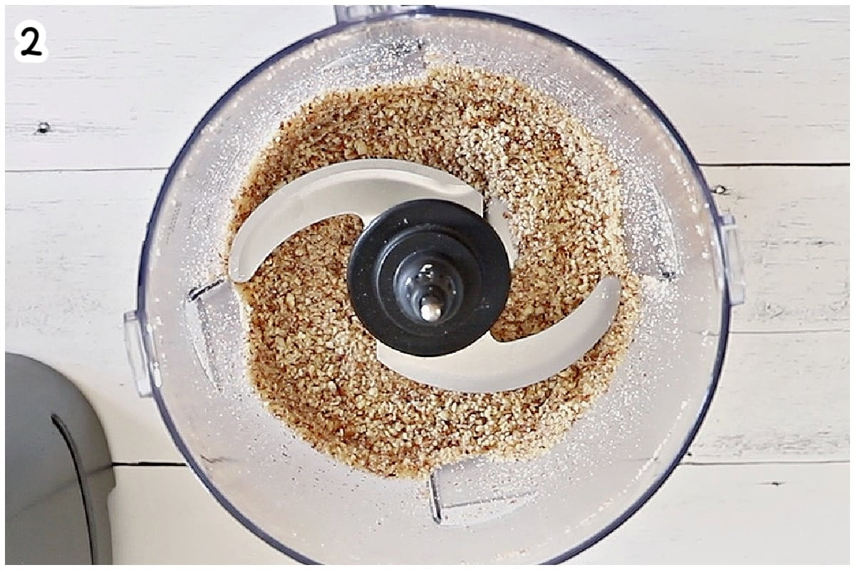 Coarsely ground almonds in a food processor bowl.