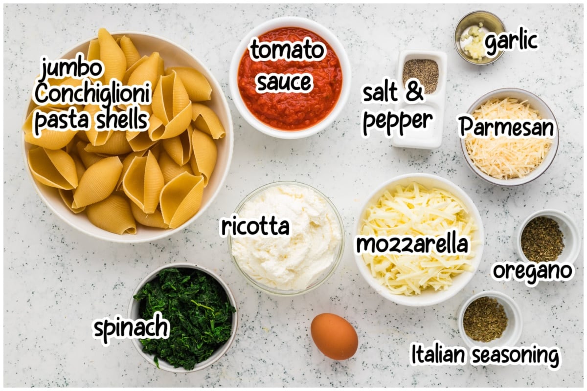 Flat lay overhead shot showing the ingredients needed to make baked stuffed shells, each labeled with text overlay.