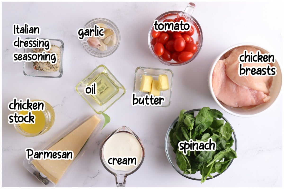 Overhead view of labeled ingredients for creamy Italian chicken arranged on a white marble surface.