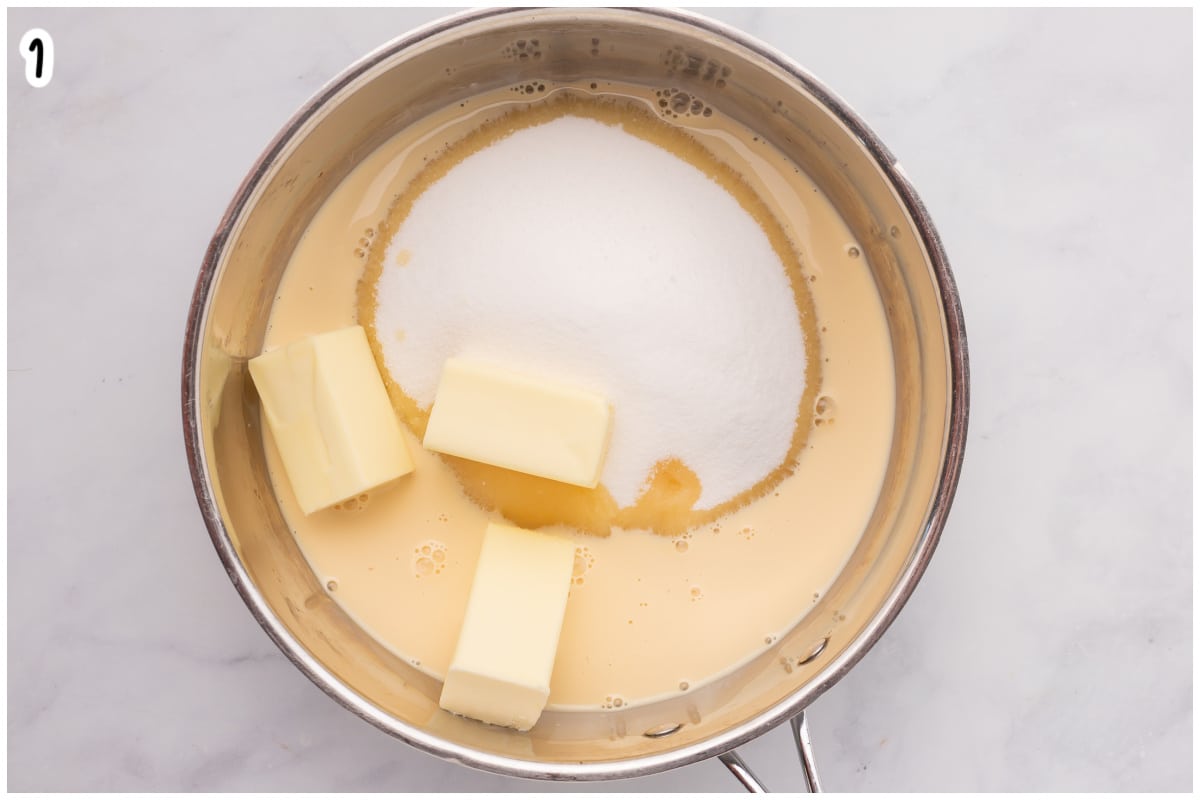 Overhead view of a metal saucepan containing evaporated milk, sugar, and butter, ready to be heated for making fantasy fudge.