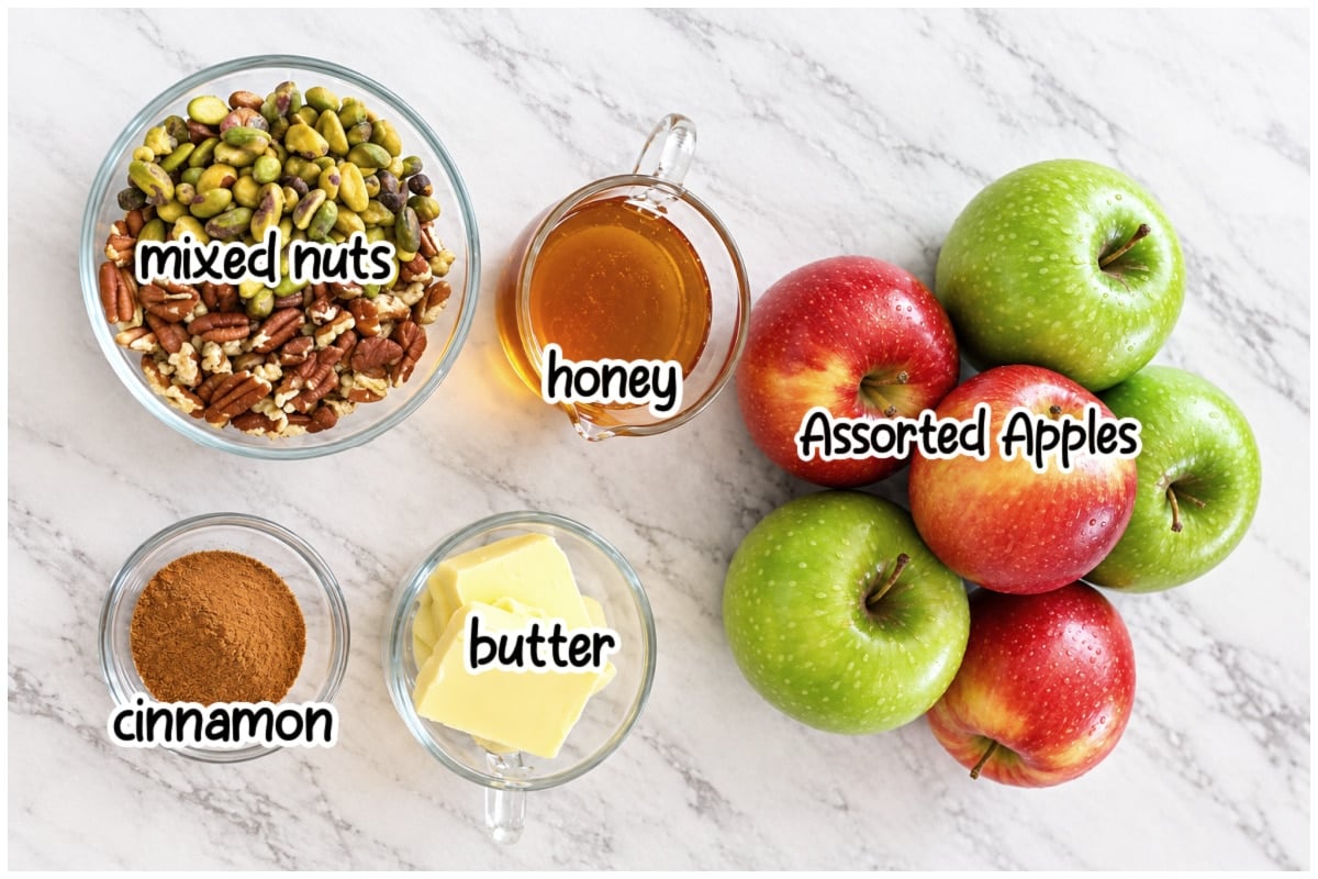 Labeled ingredients for baked apple slices on a marble counter.